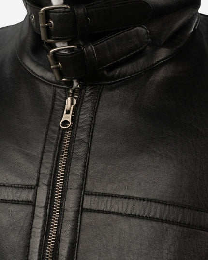 Close-up of a black leather jacket with a zipper and buckle detail.