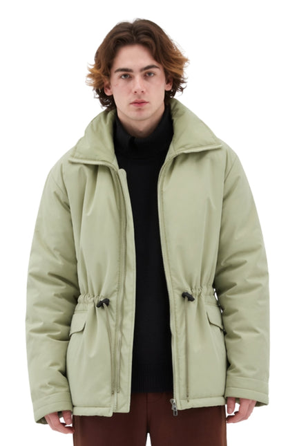 Person wearing a light green jacket on a white background