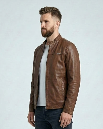 Man wearing a brown leather jacket on a light gray background
