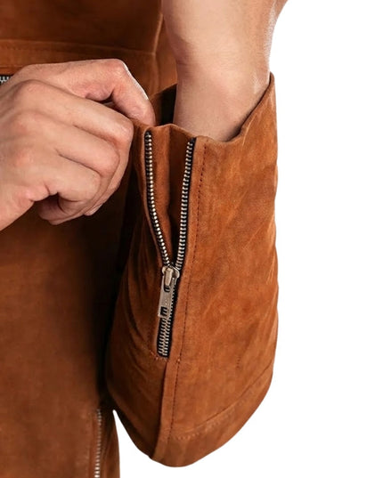 Close-up of a brown leather jacket with a zipper being pulled.