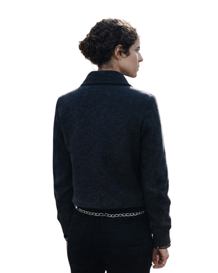 Person wearing a dark jacket on a white background