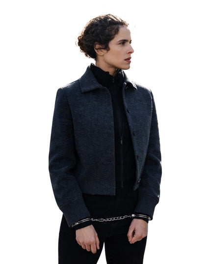 Person wearing a dark gray coat on a white background