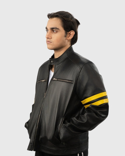 Man wearing a black leather jacket with yellow stripes on a white background