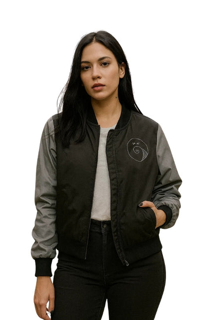 Woman wearing a black and gray bomber jacket with a logo on a white background