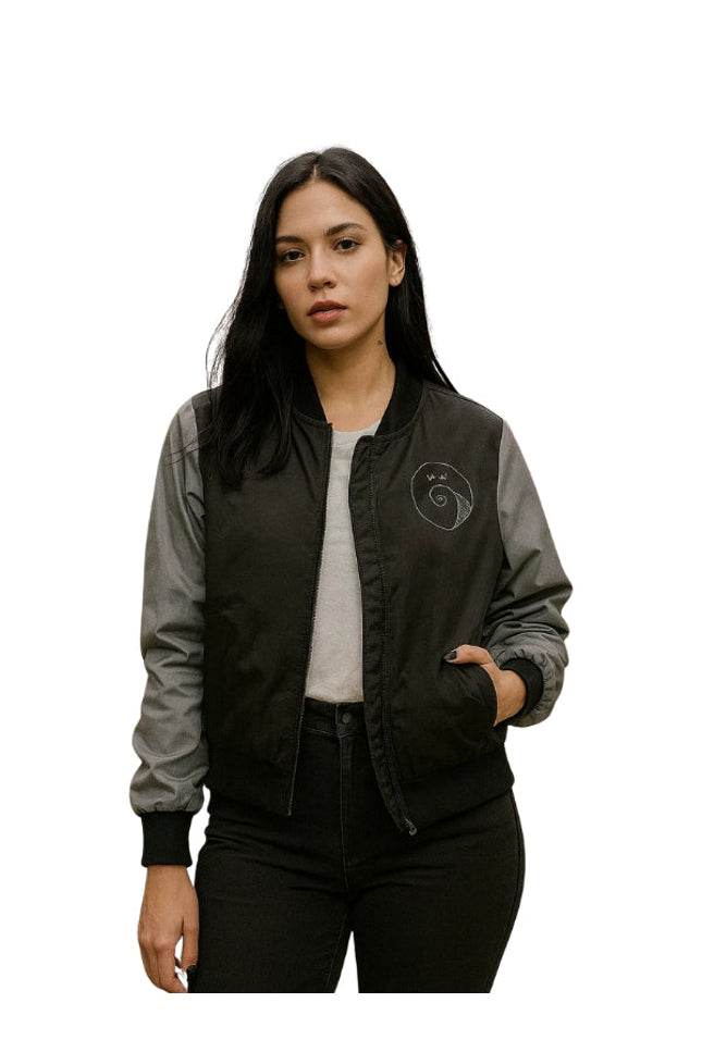 Woman wearing a black and gray bomber jacket with a logo on a white background