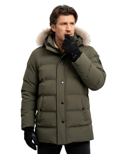 Man wearing a green winter coat with a fur-lined hood on a white background
