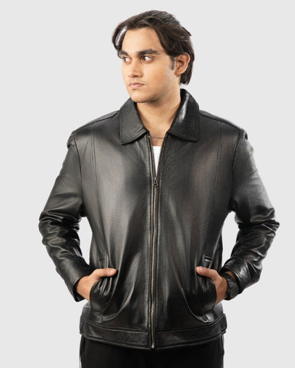 Man wearing a black leather jacket on a gray background