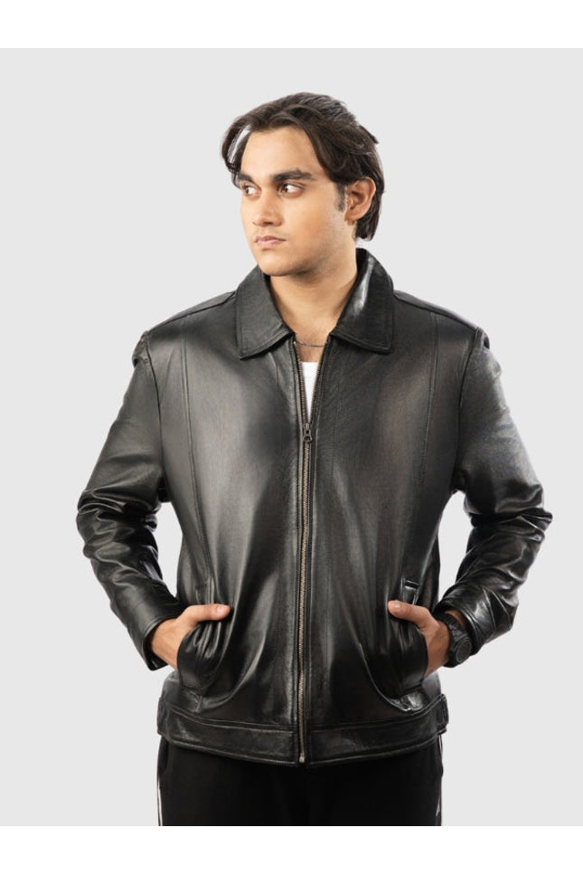 Man wearing a black leather jacket on a gray background