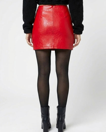 Person wearing a red leather skirt and black boots on a white background