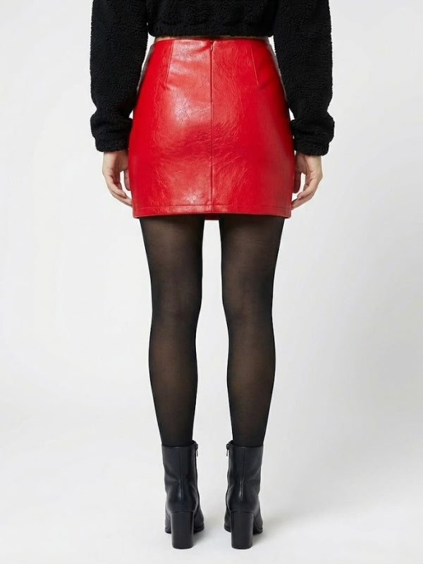 Person wearing a red leather skirt and black boots on a white background
