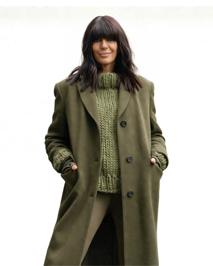 Woman wearing a green coat over a green knitted sweater on a white background