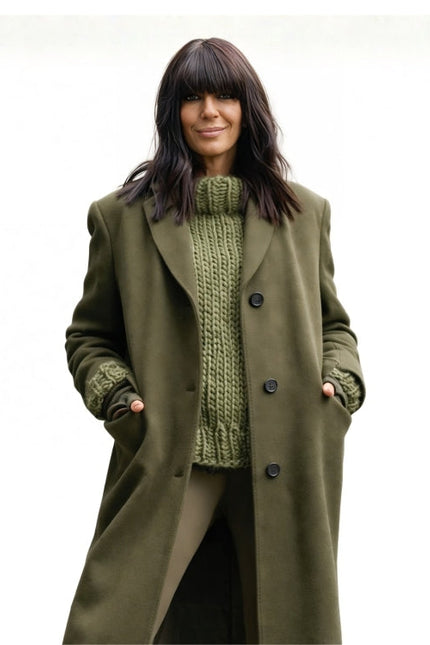 Woman wearing a green coat over a green knitted sweater on a white background