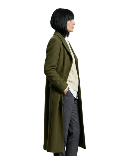 Person wearing a long olive green coat on a white background