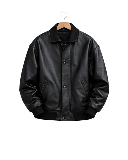 Black leather jacket on a hanger against a white background