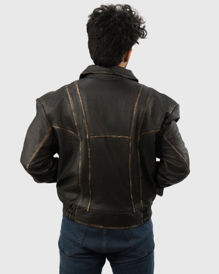Person wearing a black leather jacket on a plain background