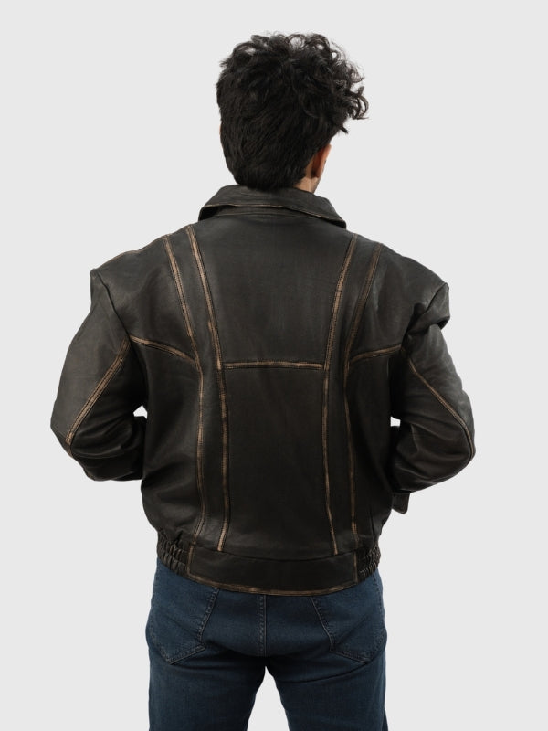 Person wearing a black leather jacket on a plain background