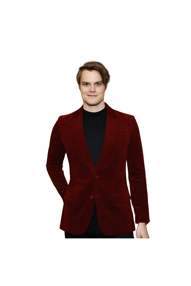 Man wearing a red velvet blazer on a white background