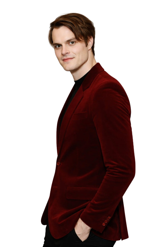 Man wearing a red velvet blazer on a white background