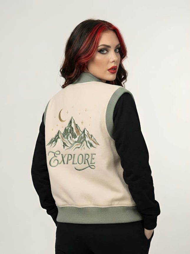 Woman wearing a jacket with a mountain design and 'EXPLORE' text on the back.