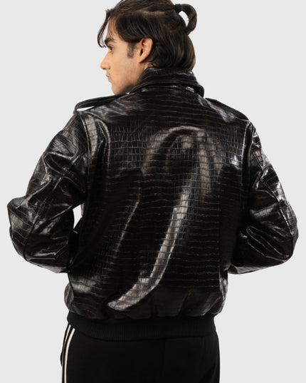 Person wearing a black leather jacket with a textured pattern on a white background
