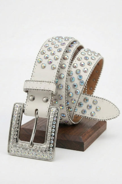 Decorative belt with rhinestones on a wooden stand against a white background