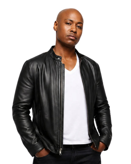 Man wearing a black leather jacket over a white shirt on a white background