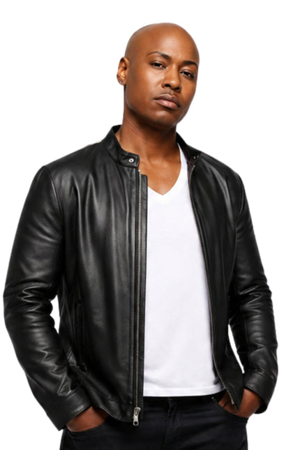 Man wearing a black leather jacket over a white shirt on a white background