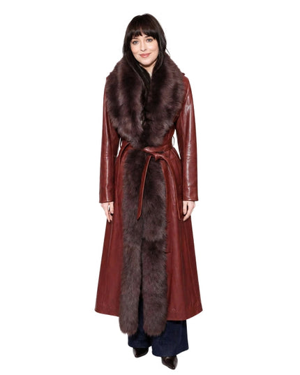 Woman wearing a long red coat with fur trim on a white background