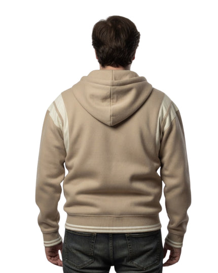 Person wearing a beige hoodie with white sleeves on a white background