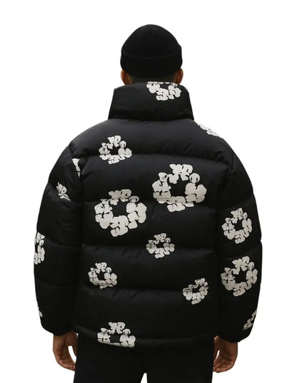 Denim Tears Wreath Black Puffer Jacket with bold logo and cozy fabric for warmth and style.