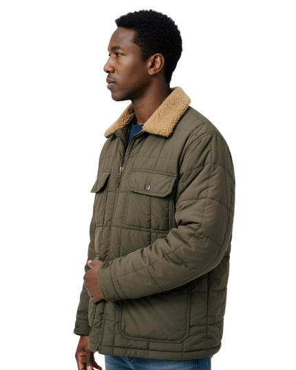 Man wearing a green quilted jacket with a beige fur collar on a white background