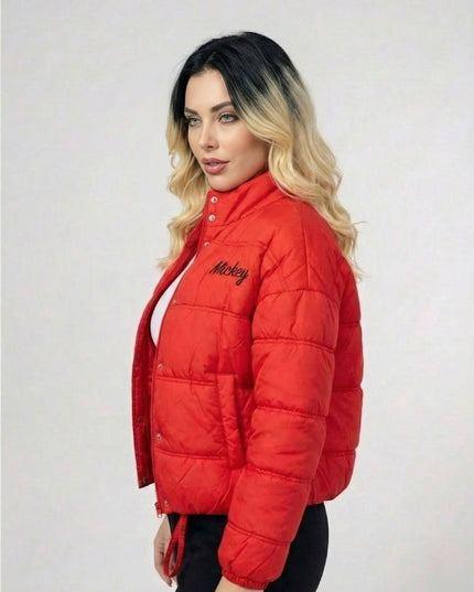 Woman wearing a red puffer jacket with 'Mickey' branding on a white background