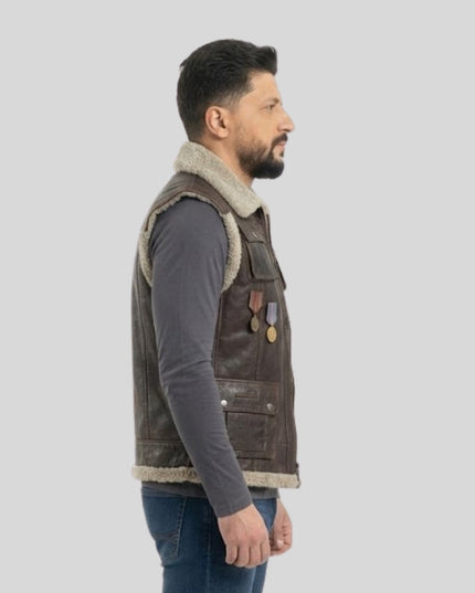 Man wearing a brown leather vest with fur lining on a light gray background