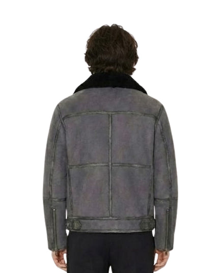 Person wearing a gray leather jacket with a white background