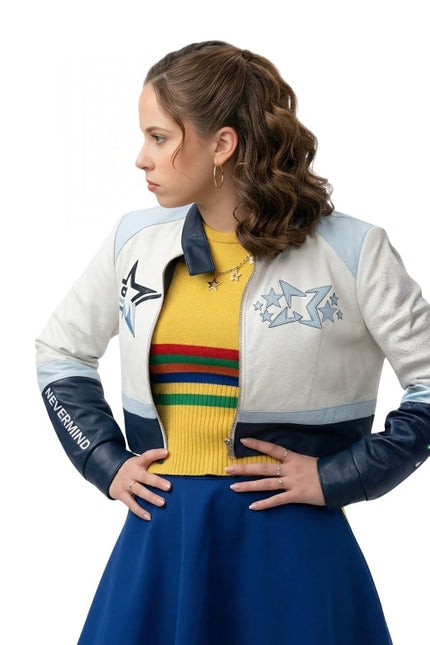 Woman wearing a colorful jacket with star designs and a yellow sweater with rainbow stripes on a white background
