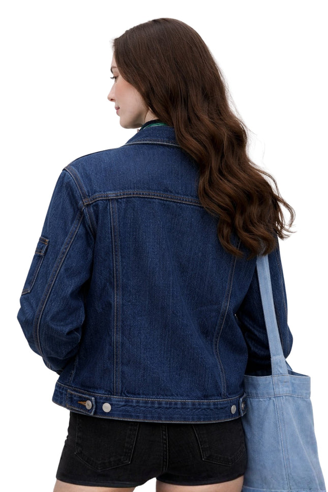 Person wearing a blue denim jacket and overalls on a white background