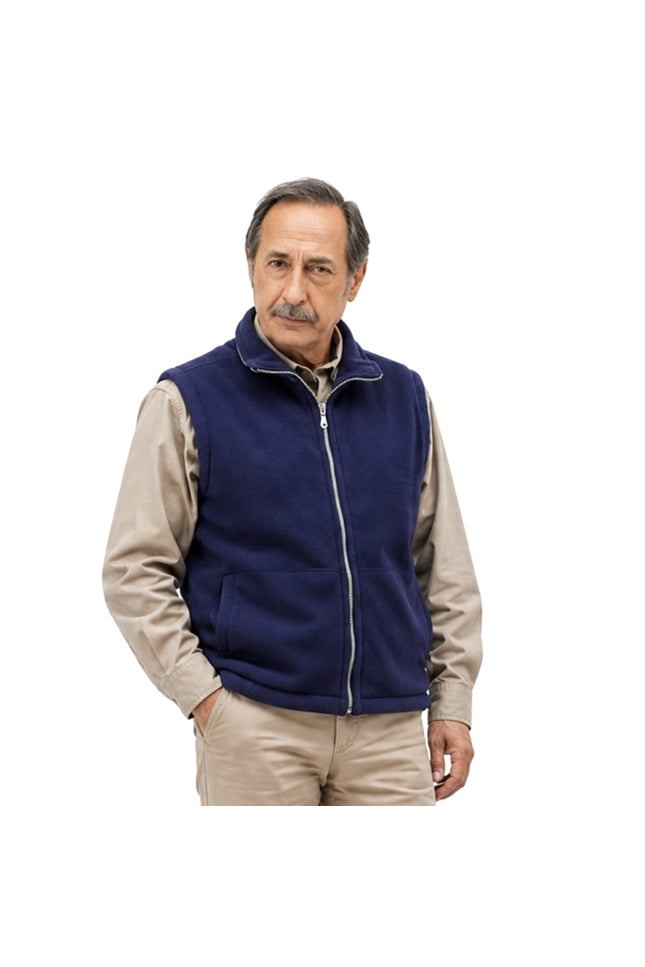 Man wearing a navy blue vest over a beige shirt on a white background