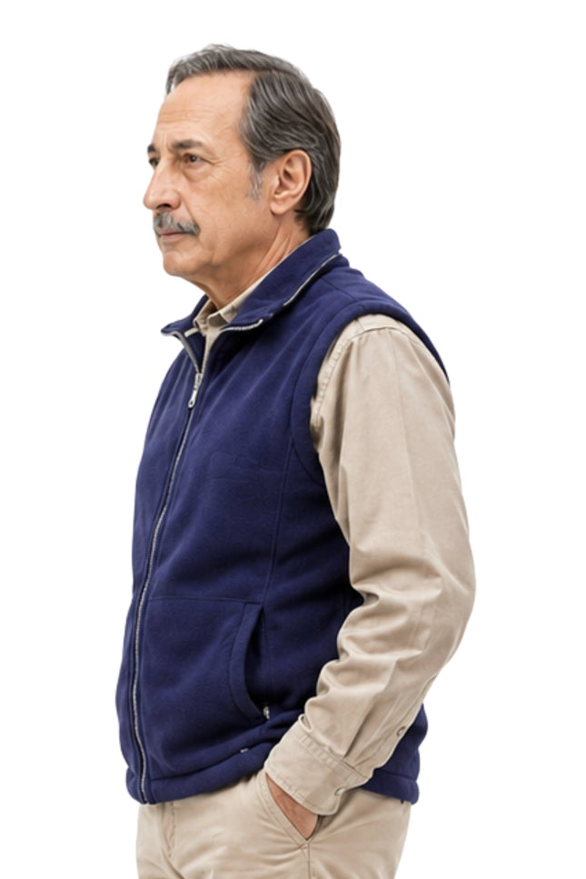 Man wearing a navy blue vest over a beige shirt on a white background