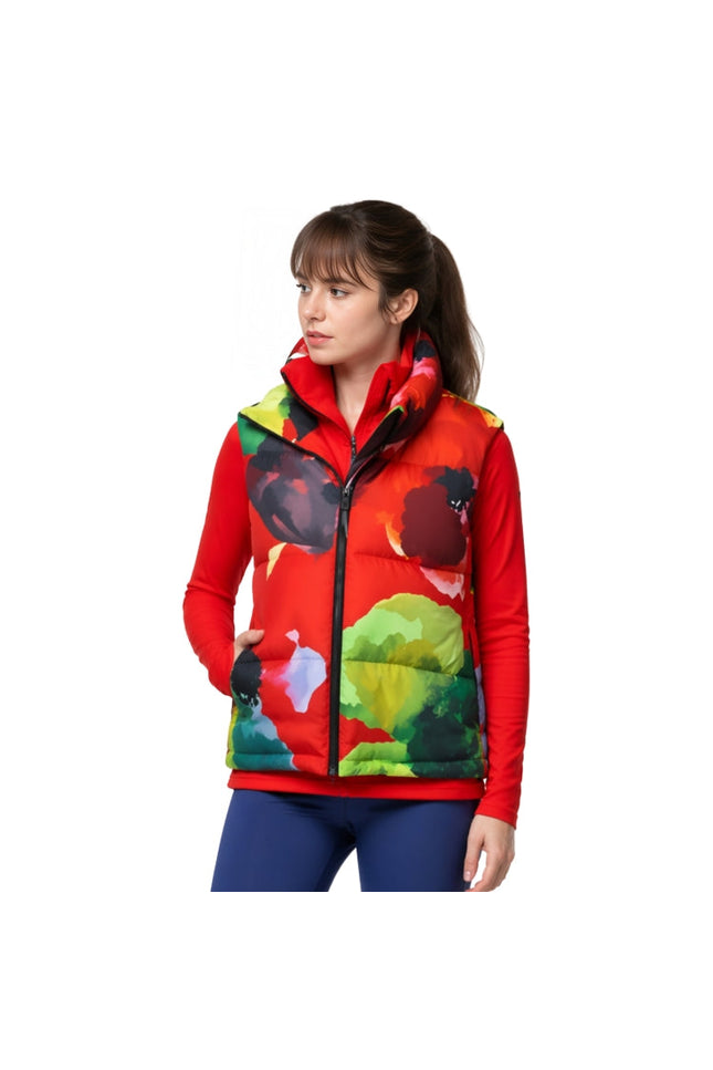 Woman wearing a colorful puffer vest with a white background
