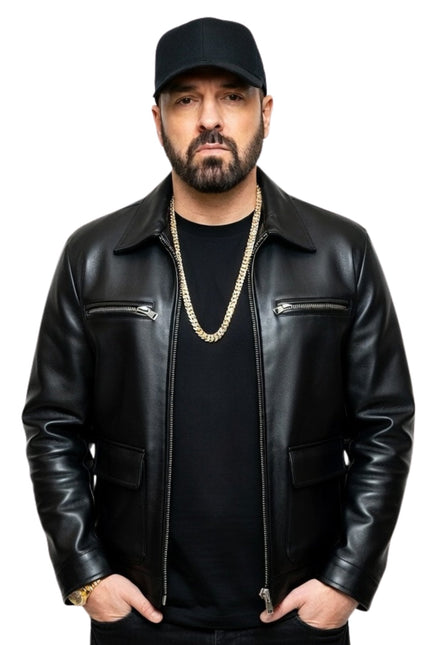 Man wearing a black leather jacket and cap on a white background