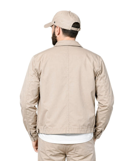 Man wearing a beige bomber jacket 