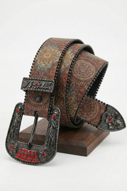 Decorative belt with intricate design and red gemstones on a white background