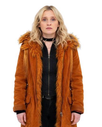 Person wearing a brown fur-lined coat on a white background