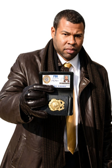 Man in a brown leather jacket holding an FBI badge and ID card on a white background