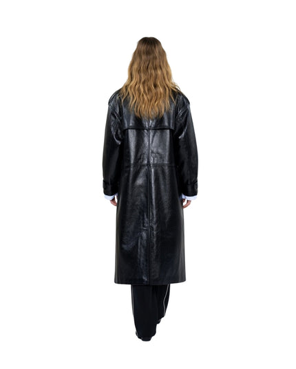 Person wearing a long black leather coat on a white background