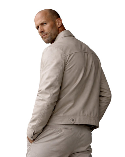 Man wearing a beige jacket and pants on a white background