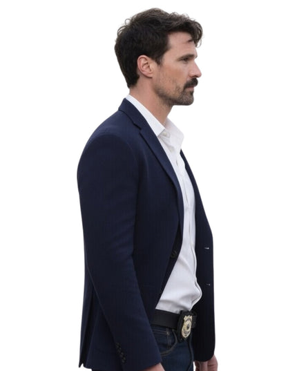 Man wearing a navy blazer over a white shirt on a white background