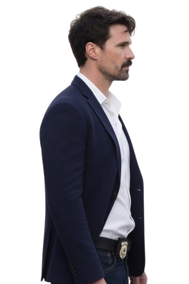 Man wearing a navy blazer over a white shirt on a white background
