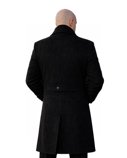 Person wearing a black coat from behind on a white background