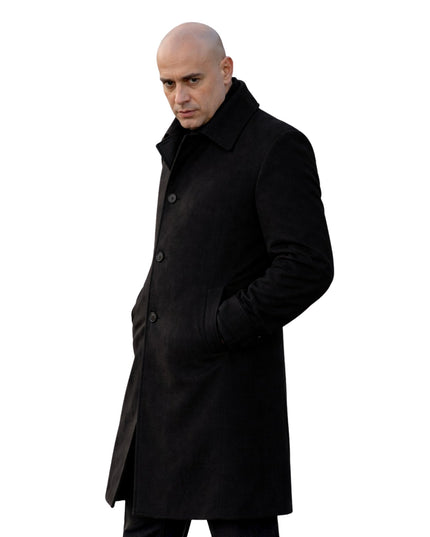 Man wearing a black coat on a white background